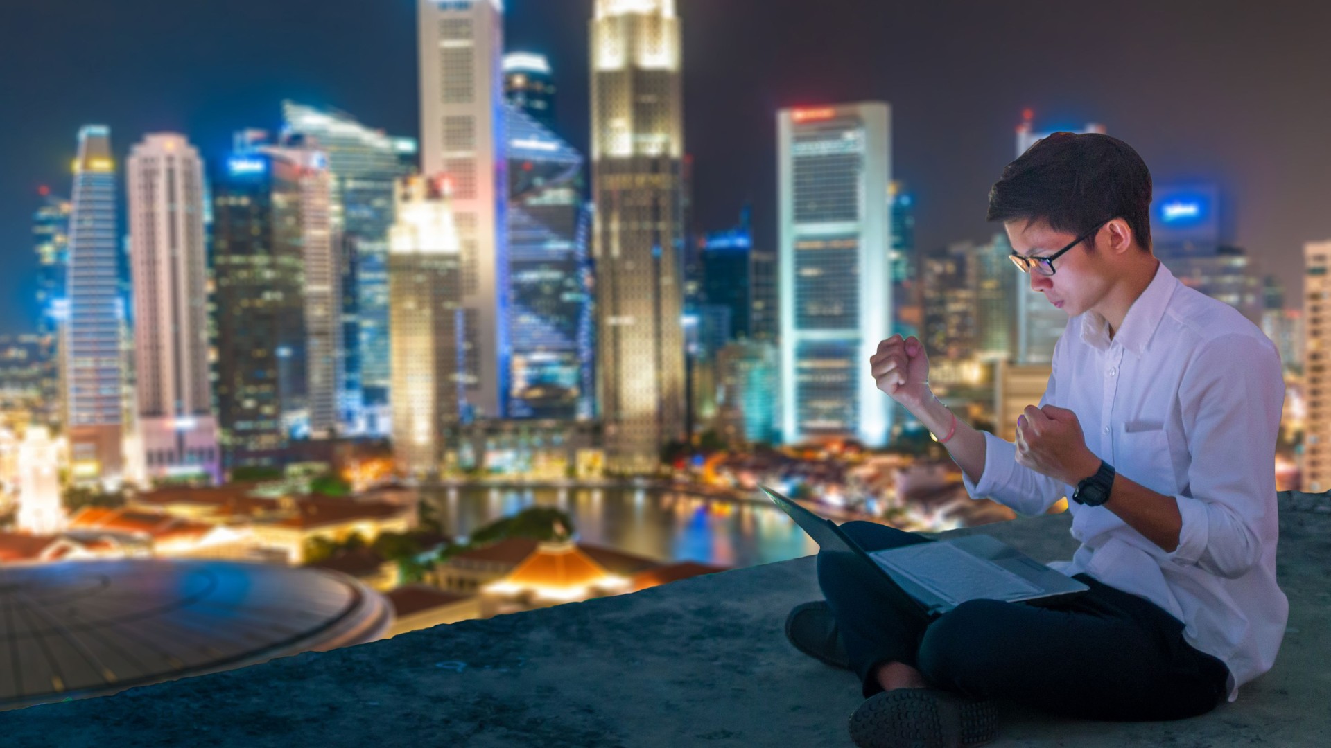 Asian business man using laptop and digital tablet in Singapore